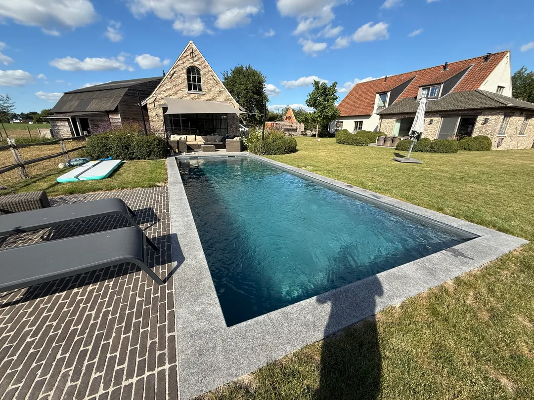 Modern zwembad met strak geplaatste grijze liner in een landelijke tuin na renovatie door Liner Plaatsen